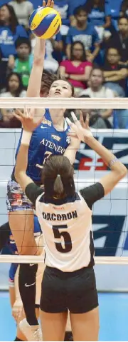  ?? MIGUE DE GUZMAN ?? Ateneo Lady Blue Eagles’ Maddie Madayag powers a spike over Adamson Lady Falcons’ Joy Dacoron in their UAAP women’s volleyball game at the Filoil Flying V Center in San Juan yesterday.