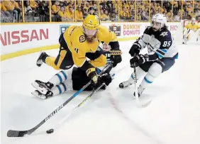  ?? MARK HUMPHREY THE CANADIAN PRESS FILE PHOTO ?? Nashville Predators defenceman Ryan Ellis jumps over a Winnipeg Jets player during Game 7 of a second-round NHL playoff series in 2018. It will take five series wins for Nashville to capture the Stanley Cup this year.