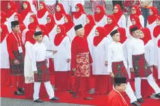  ??  ?? MARCHING IN STEP: United Malays National Organisati­on (UMNO) party President and Malaysian Prime Minister Najib Razak, centre, at UMNO party’s general assembly.