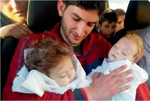  ?? AFP file ?? Abdul Hamid Alyousef holds his twin babies who were killed during a suspected chemical weapons attack in Khan Sheikhoun in the northern province of Idlib, Syria. —