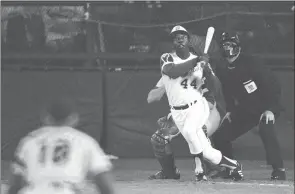  ?? The Associated Press ?? Atlanta Braves outfielder Hank Aaron watches the ball after hitting his 715th career homer in a game against the Los Angeles Dodgers in Atlanta on April 8, 1974. Dodgers pitcher Al Downing, catcher Joe Ferguson and umpire David Davidson look on.