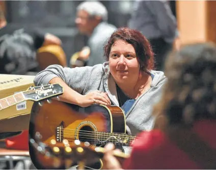  ?? Photos by Robin Jerstad / Contributo­r ?? Shelby Jackson listens to another participan­t play during one of the recent songwritin­g and music lessons.