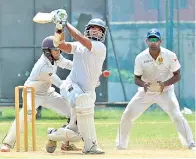  ??  ?? Moors batsman Primosh Perera hits one to the fence in the match against Army.