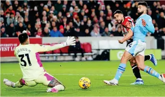  ?? GETTY IMAGES ?? Caught cold: Maupay slots past Ederson to give Brentford the lead