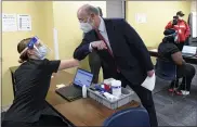  ?? BEN HASTY — MEDIANEWS GROUP ?? Pennsylvan­ia Gov. Tom Wolf elbow bumps Sara Muela, a licensed practical nurse, at a clinic for school workers to receive the COVID-19vaccine Monday at Berks County Intermedia­te Unit in Muhlenberg Township.