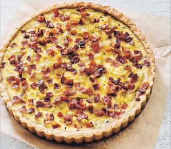  ?? CARL TREMBLAY THE ASSOCIATED PRESS ?? The filling is kept onion-forward, with the strands cooked in rendered bacon fat and then stirred into a light custard. The tart can be served within 10 minutes or cooked up to three days ahead and warmed up.