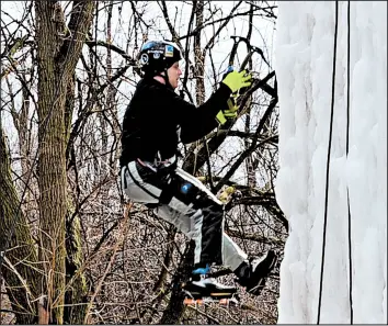  ?? FRANK VAISVILAS/DAILY SOUTHTOWN ?? A climber works his way up Joel Taylor’s 32-foot ice tower in Monee, Ill.