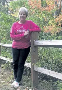  ?? ABOVE: CHERYL CUDDAHY / SENTINEL & ENTERPRISE; BOTTOM, COURTESY CUP CRUSADERS ?? Kathy DiRusso may have taken a break from dyeing her hair shades of pink, but she has not taken a break in fighting for a cure for breast cancer along with her Cup Crusaders, below, at a walk in Philadelph­ia in 2017.