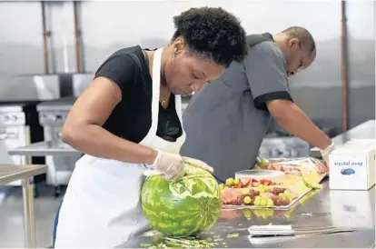  ?? KIM HAIRSTON/BALTIMORE SUN ?? Nacole Lee, owner of Frucasion Fruit Boutique, and her husband, Robert Lee, work in B-More Kitchen in Homeland, one of several food incubators in Baltimore that provide members with low-cost commercial kitchen space and services.