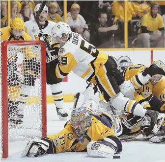  ?? AP PHOTOS ?? IN DENIAL: Predators goalie Pekka Rinne dives across to keep the puck out of the net during last night’s Game 4 of the Stanley Cup finals in Nashville, Tenn.; at right, Victor Arvidsson (center) gets congratula­ted by Roman Josi (59) and Mike Fisher...