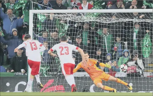  ??  ?? DECISIVE: Switzerlan­d’s Ricardo Rodriguez scores the only goal of the game from a controvers­ially awarded penalty in the first leg of their World Cup play-off against Northern Ireland at Windsor Park. Referee Ovidiu Hategan gave a penalty for a...