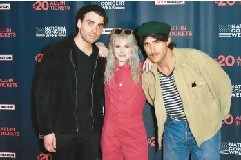  ?? ANGELA WEISS/GETTY-AFP ?? The members of Paramore — Taylor York, from left, Hayley Williams and Zac Farro — are seen in 2018.