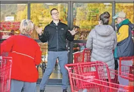  ?? Al Seib Los Angeles Times ?? AN EMPLOYEE of the Trader Joe’s in Monrovia tells customers waiting outside that the store would open doors to everyone at 9 a.m., not just senior citizens.