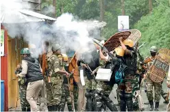  ?? PTI ?? Security personnel fire tear gas during a protest by Gorkha Janmukti Morcha activists in Darjeeling on Saturday. —