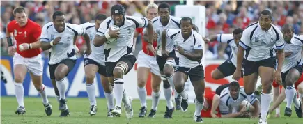  ?? Photo: World Rugby ?? Flying Fijians flanker Akapusi Qera (with ball) in full flight with support (left-right) Jone Railomo, Graham Dewes, Ifereimi Rawaqa, Seremaia Bai, Kameli Ratuvou (on ground), Sunia Koto, Sisa Koyamaibol­e, Mosese Rauluni against Wales during the 2007 World Cup. Fiji won 38-34.