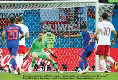  ?? AFPPIX ?? Colombia’s Falcao (2nd right) scores against Poland’s goalkeeper Wojciech Szczesny during their Russia 2018 World Cup Group H match at the Kazan Arena in Kazan earlier today. –