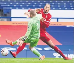  ?? AFP ?? Everton’s Jordan Pickford, left, clashes with Liverpool’s Virgil van Dijk.