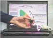  ??  ?? Engineer James Scholtz holds a spectral sensor module that measures color perception.