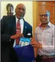  ??  ?? Dr. Frank G. Pogue, Cheyney University of Pennsylvan­ia Interim President (left), presents a copy of “A Living Legend: A History of Cheyney University,” by Charlene Conyers, to Cheyney’s Fulbright Scholar in Residence, Dr. Luvuyo Dondolo (right), senior...