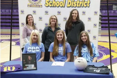  ?? The Sentinel-Record/Richard Rasmussen ?? ■ Fountain Lake High School volleyball player Presley Hamric, sitting center, signed to play at Central Baptist College Wednesday morning in a ceremony in Irvin J. Bass Gymnasium. Hamric was joined by her mother, Valerie Hamric, sitting left, sister Payton Hamric, sitting right, assistant coach Michaela Biehlisch, standing left, head coach Tina Moore and CBC head coach Stephanie Irwin.