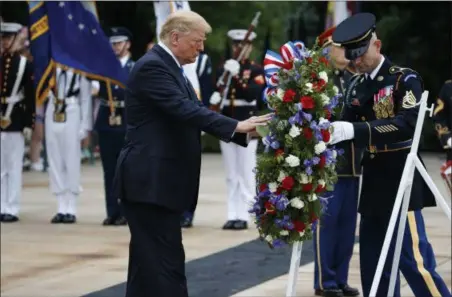  ?? EVAN VUCCI — THE ASSOCIATED PRESS ?? President Donald Trump lays a wreath during a Memorial Day ceremony at Arlington National Cemetery Monday in Arlington, Va.