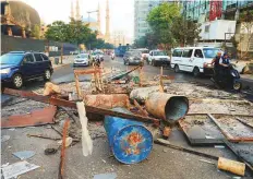  ?? Reuters ?? Cars drive past debris at a protest site in Lebanon yesterday.