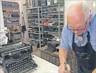  ?? AP FILE ?? In this Jan. 9, 2017, photo, John Lewis, a typewriter repairman, works at his shop in Albuquerqu­e, N.M., in front of his collection of vintage typewriter­s. The vintage typewriter is making a comeback with a new generation of fans gravitatin­g to...