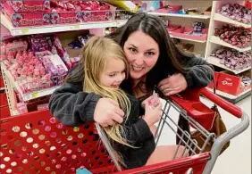  ?? Kathleen Moore / Times Union ?? Jenna Dodd of Burnt Hills hugs her daughter Mila, 3. Dodd kept her son home from school the first year he was eligible for kindergart­en, sending him the year he turned 6. She might do the same with Mila because she is shy due to the lack of early socializat­ion because of COVID, Dodd says.