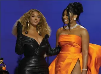  ?? AP ?? TOP PERFORMER: Beyonce, left, and Megan Thee Stallion accept the award for best rap song for ‘Savage’ at the 63rd annual Grammy Awards at the Los Angeles Convention Center on Sunday.