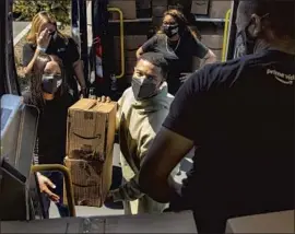  ?? Photograph­s by Jay L. Clendenin Los Angeles Times ?? MICHAEL B. JORDAN loads boxes of food and household items Thursday at the Amazon Fresh store in Ladera Heights for distributi­on to L.A.-area veterans.