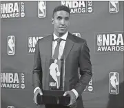  ?? Evan Agostini / Invision / AP ?? Rookie of the Year winner Malcom Brogdon poses with his trophy at the NBA Awards on Monday in New York.