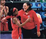  ?? Morry Gash / Associated Press ?? Arizona guard Aari McDonald, left, celebrates with head coach Adia Barnes at the end of a Final Four game against UConn on Friday at the Alamodome in San Antonio. Arizona won 69-59.