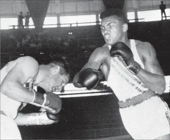  ?? THE ASSOCIATED PRESS ?? Cassius Clay throws a right at Tony Madigan of Australia during the light heavyweigh­t boxing semi-finals at the Summer Olympic Games in Rome, Sept. 3, 1960.