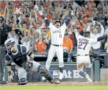  ?? DAVID J. PHILLIP/THE ASSOCIATED PRESS ?? Houston Astros’ Jose Altuve reacts after scoring the game-winning run past New York Yankees catcher Gary Sanchez during the ninth inning of Game 2 of the American League Championsh­ip Series, on Saturday, in Houston. The Astros won 2-1 to take a 2-0...