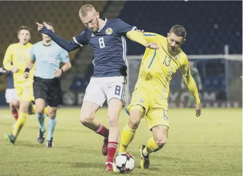  ??  ?? 0 Scotland striker Oli Mcburnie battles for the ball with Ukraine’s Ivan Zotko during last night’s defeat at Mcdiarmid Park.