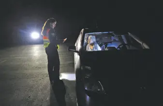  ?? Nick Otto / Special to The Chronicle ?? Motorist Claire Miller waits for evacuation orders to be lifted amid power shutoffs during an October fire in Moraga. PG&E cut power to millions of customers, often with little notice.