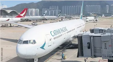  ??  ?? A Cathay Pacific plane taxis at Hong Kong Internatio­nal Airport. Several employees of state-owned mainland Chinese companies say there is an “unspoken rule” among colleagues not to fly with Cathay.