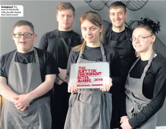  ??  ?? Delighted The team at Windmills Cafe proudly display their latest award