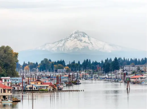  ?? ?? Bottom: Mount Hood serves as a picturesqu­e backdrop for Portland, Oregon’s Hayden Island, which is home to Schooner Creek Boat Works.