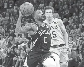  ?? MARK HOFFMAN/MILWAUKEE JOURNAL SENTINEL ?? Bucks guard Damian Lillard scores on a fast break during the second overtime Tuesday at Fiserv Forum in Milwaukee.