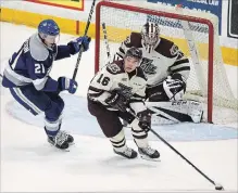  ?? CLIFFORD SKARSTEDT EXAMINER ?? Peterborou­gh Petes’ Nick Robertson clears the puck away from Sudbury Wolves’ Nolan Hutcheson as goalie Hunter Jones looks on during second period OHL action on Oct. 25 at the Memorial Centre.