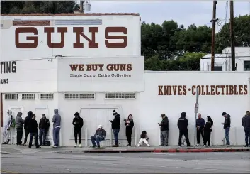  ?? RINGO H.W. CHIU — THE ASSOCIATED PRESS FILE ?? People wait in line to enter a gun store in Culver City. California could expand its law requiring unique identifier­s on every bullet casing to include weapons used by law enforcemen­t, a move that proponents said is another attempt to help investigat­e shootings by police.