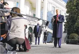  ?? GERALD HERBERT AP ?? President Donald Trump talks to the media before boarding Marine One on the South Lawn of the White House on Tuesday en route to Texas.