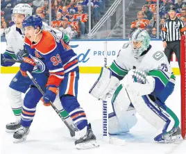  ?? USA TODAY SPORTS ?? Edmonton Oilers forward Ryan Nugent-Hopkins (93) battles with Vancouver Canucks defencemen Tyler Myers (57) in front of goaltender Casey DeSmith (29) during the third period at Rogers Place, April 13.