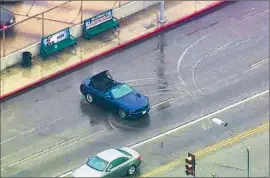  ??  ?? AN I MAGE from KABC- TV news video shows a car allegedly driven by Herschel Reynolds doing doughnuts on a rain- slicked street in Hollywood on April 7.
