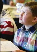  ?? JEFF TAYLOR / THE WINCHESTER STAR 2015 ?? In this 2015 photo, Trey Craft, 11, a sixth-grader in Frederick County, Va., concentrat­es on a math problem during the Blue Ridge MathCounts Competitio­n.