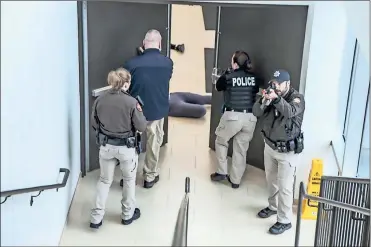  ?? / Contribute­d ?? A team of first responders methodical­ly move through the Catoosa County Campus during an “active shooter” drill on Nov. 30. From left: Deputy Leeann Moody, Catoosa County Sheriff’s Department; Deputy Doug Licklider, Catoosa County Sheriff’s Department; Detective Jennifer Jones, Ringgold Police De-partment (GNTC police); and Nigel Torres, Catoosa County Sheriff’s Department.