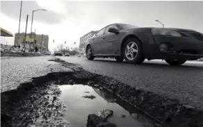  ?? Carlos osorio/the assoCiateD Press/Files ?? It’s pothole season, so be sure to inspect your vehicle and tires regularly for damage.