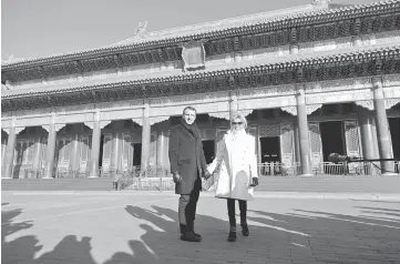  ?? — Reuters photos ?? President Macron and his wife Brigitte pose during their visit to the Forbidden City, in Beijing, China, last Tuesday. (Below) Macron and Brigitte visit the Great Mosque of Xian in the city of Xian, Shaanxi province, China, recently.