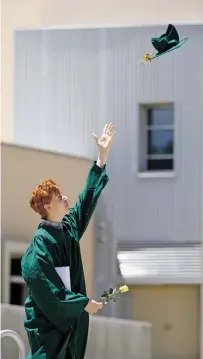  ?? PHOTOS BY LUIS SÁNCHEZ SATURNO/THE NEW MEXICAN ?? Connor Dale, 18, throws his cap in the air after collecting his diploma during the Los Alamos High School commenceme­nt ceremony on May 28. The school held a commenceme­nt ceremony for each student individual­ly. ‘Although it might be inconvenie­nt to have in the circumstan­ces that it is, it’s still a very momentous achievemen­t for a lot of us,’ Dale said.